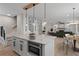 Open-concept kitchen with a large island, stainless steel appliances, and stylish pendant lights at 2517 Hampton Park Ct, Marietta, GA 30062