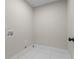 The laundry room features tile flooring, utility hookups and electrical outlets for a modern experience at 2517 Hampton Park Ct, Marietta, GA 30062