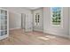 Sunlit living room with hardwood floors, large windows, and elegant French doors at 2517 Hampton Park Ct, Marietta, GA 30062