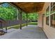 Covered patio with concrete floor and wooden beams perfect for outdoor entertaining at 2517 Hampton Park Ct, Marietta, GA 30062