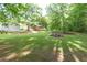 View of the backyard showcasing the lawn, trees and a building at 5670 Lanny Dr, Powder Springs, GA 30127