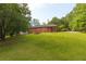 Spacious backyard and exterior view showcasing the home's structure and landscaping at 5670 Lanny Dr, Powder Springs, GA 30127