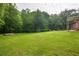 Spacious backyard with a well-maintained lawn and partial view of the house at 5670 Lanny Dr, Powder Springs, GA 30127