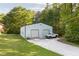 Spacious barn with multiple bays, concrete pad, truck parked in front and manicured lawn at 5670 Lanny Dr, Powder Springs, GA 30127