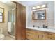 Bathroom featuring a glass-enclosed shower, a light wood vanity and neutral colors at 5670 Lanny Dr, Powder Springs, GA 30127