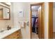 This bathroom boasts a light wood vanity and provides access to a walk-in closet at 5670 Lanny Dr, Powder Springs, GA 30127