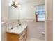 This bathroom features a tiled shower/tub, a vanity with plenty of storage and a classic lighting fixture at 5670 Lanny Dr, Powder Springs, GA 30127