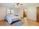 This bedroom boasts hardwood floors, a ceiling fan, and an en suite bathroom at 5670 Lanny Dr, Powder Springs, GA 30127