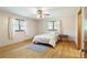 This bedroom boasts hardwood floors, two windows for ample light, and neutral colored walls at 5670 Lanny Dr, Powder Springs, GA 30127