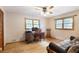 Comfortable bedroom with hardwood floors, ceiling fan, and natural light at 5670 Lanny Dr, Powder Springs, GA 30127