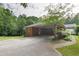 Brick carport area and exterior view showcasing the home's structure and landscaping at 5670 Lanny Dr, Powder Springs, GA 30127