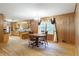 Open concept dining area with wood floors, lots of windows and wood paneling at 5670 Lanny Dr, Powder Springs, GA 30127