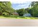 Property featuring a brick home and a large metal outbuilding with generous lawn at 5670 Lanny Dr, Powder Springs, GA 30127