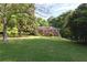 Charming brick home with a welcoming screened-in porch and lush, green lawn at 5670 Lanny Dr, Powder Springs, GA 30127