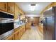 Bright kitchen with stainless steel appliances, wooden cabinets and an adjoining dining area at 5670 Lanny Dr, Powder Springs, GA 30127