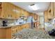 Well-lit kitchen boasts granite countertops, hardwood floors, and stainless steel appliances at 5670 Lanny Dr, Powder Springs, GA 30127