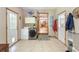 Spacious laundry room featuring modern appliances and access to the backyard at 5670 Lanny Dr, Powder Springs, GA 30127