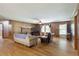 Comfortable living room featuring hardwood floors, brick fireplace, and wood paneling at 5670 Lanny Dr, Powder Springs, GA 30127