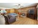 Inviting living room with hardwood floors, fireplace, wood paneling, and ample natural light at 5670 Lanny Dr, Powder Springs, GA 30127