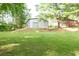 View of the backyard with a large metal outbuilding at 5670 Lanny Dr, Powder Springs, GA 30127