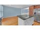 Open kitchen features hardwood flooring, granite counters, white cabinets and stainless steel appliances at 6206 Carriage Gate Se Ln # 6, Mableton, GA 30126