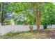 The fenced-in backyard is surrounded by mature trees, providing privacy and a natural backdrop for outdoor enjoyment at 1321 Waterton Trl, Douglasville, GA 30134