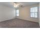 Bedroom with neutral walls, plush carpet, and natural light from two windows at 1321 Waterton Trl, Douglasville, GA 30134