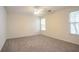 Bedroom with neutral walls, plush carpet, and natural light from two windows at 1321 Waterton Trl, Douglasville, GA 30134