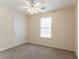 Bedroom featuring carpeted floor, natural light, and a door to the hallway at 1321 Waterton Trl, Douglasville, GA 30134