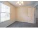 Neutral bedroom with a ceiling fan, carpeted floors, and a large window at 1321 Waterton Trl, Douglasville, GA 30134