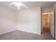 Neutral bedroom with a ceiling fan, carpeted floors, and a large window at 1321 Waterton Trl, Douglasville, GA 30134