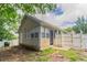 Side view of a single-story home with an enclosed porch area and a fenced yard at 1321 Waterton Trl, Douglasville, GA 30134