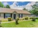 Inviting home featuring manicured front yard, tidy landscaping, and a charming covered porch at 1321 Waterton Trl, Douglasville, GA 30134