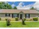 Charming home featuring a covered porch, well-maintained lawn, and classic window shutters at 1321 Waterton Trl, Douglasville, GA 30134