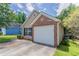 Angle view of the house exterior featuring a single car garage and manicured lawn in a residential community at 1321 Waterton Trl, Douglasville, GA 30134