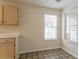 Eat-in kitchen features neutral walls, tile flooring, and natural light from two windows at 1321 Waterton Trl, Douglasville, GA 30134