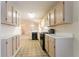 Efficient kitchen featuring tan cabinetry, black gas range, and an overhead microwave at 1321 Waterton Trl, Douglasville, GA 30134