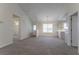 Open concept living area featuring new carpet, neutral walls, and a clear view to the front entry at 1321 Waterton Trl, Douglasville, GA 30134