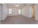 Spacious living room with plush carpeting, neutral paint, and ample natural light showcasing a ceiling fan at 1321 Waterton Trl, Douglasville, GA 30134