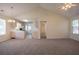 Inviting living space featuring plush carpeting, neutral paint, and seamless flow into the adjacent kitchen at 1321 Waterton Trl, Douglasville, GA 30134