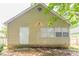Rear exterior view shows neutral siding, a white door, and windows complementing this cozy home at 1321 Waterton Trl, Douglasville, GA 30134