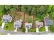 Aerial view of neighborhood homes, displaying their layout and yard sizes with mature trees at 4963 Kingsbridge Ct, Powder Springs, GA 30127
