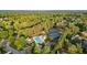 A high angle of community amenities, with mature trees surrounding a pool and tennis courts at 4963 Kingsbridge Ct, Powder Springs, GA 30127