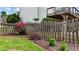 Backyard with a wooden fence, colorful garden, and a raised deck offering a private outdoor space at 4963 Kingsbridge Ct, Powder Springs, GA 30127