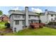 Backyard view showcasing a multi-story home with a deck and a well-maintained lawn at 4963 Kingsbridge Ct, Powder Springs, GA 30127