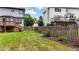 Spacious backyard with a well-maintained lawn, wooden fence, and a small deck with stairs leading to the house at 4963 Kingsbridge Ct, Powder Springs, GA 30127