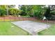 Community basketball court is surrounded by trees and fencing at 4963 Kingsbridge Ct, Powder Springs, GA 30127