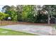 Community basketball court has two hoops and is surrounded by fencing at 4963 Kingsbridge Ct, Powder Springs, GA 30127