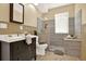 Updated bathroom with modern vanity, tiled shower, and wood-look tile flooring at 4963 Kingsbridge Ct, Powder Springs, GA 30127