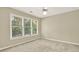 Cozy bedroom with a large window showcasing outdoor views, and neutral wall color at 4963 Kingsbridge Ct, Powder Springs, GA 30127